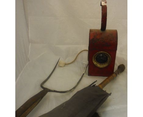 A Victorian umbrella with carved wooden handle, an elm handled pitch fork and a converted road lamp marked "Sand Star"