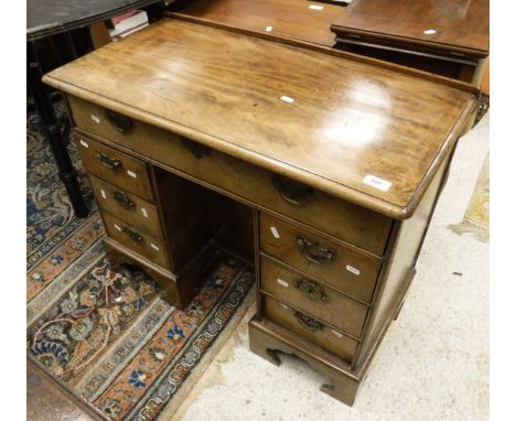 A 19th Century mahogany kneehole desk of small proportions, the plain top above single drawer, raised on twin pedestals of th