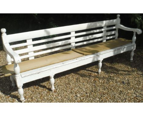 A white painted slat-back bench 