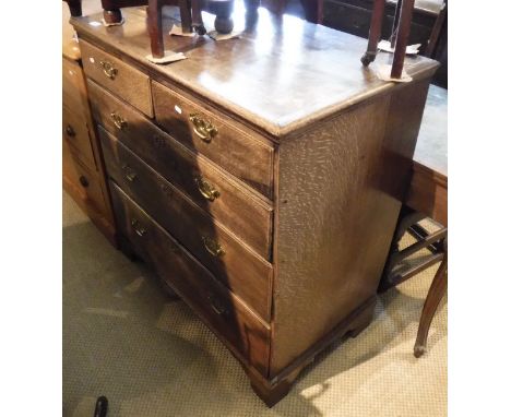 An 18th Century oak and mahogany banded North Country chest of two short over three long graduated drawers to bracket feet