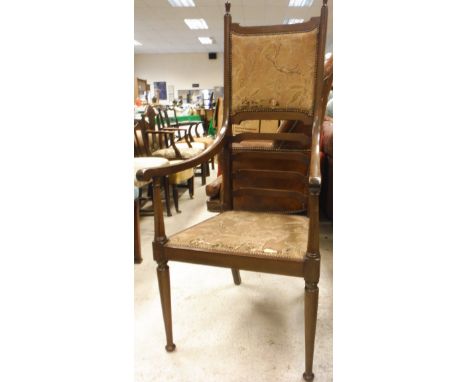 A mahogany framed ladder back chair with upholstered seat and back on turned tapering supports to bun feet