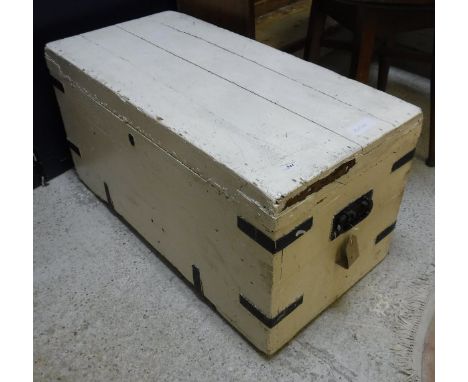 A painted pine trunk, the hinged top opening to reveal a plain interior with twin wrought iron handles and a slat back rockin