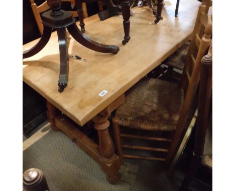 A 20th Century modern beech topped dining table on pine base, together with six ladder back beech framed and rush seated chai