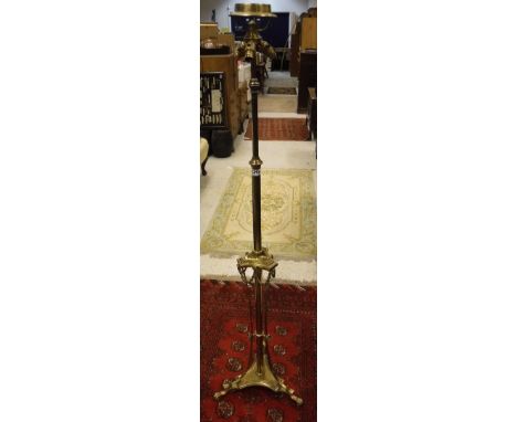 A brass floor lamp in the French Empire taste