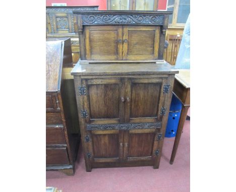 Oak Small Buffet Sideboard Circa 1930's, with three pairs of stacking cupboard doors, half wheel and scroll carving, butterfl