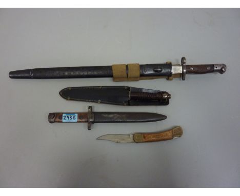 WWI bayonet with scabbard, an other, dagger with turned wood hilt and a skinning knife