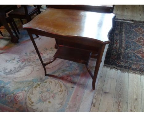 An Edwardian mahogany, inlaid and crossbanded occasional table, with lower shelf uniting splayed supports (74cm wide).