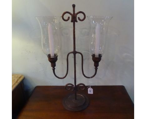 A metalware two branch French-style candlestick, having glass shades (60cm).