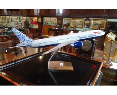 A scale model of a British Airways Boeing 777 aircraft, manufactured by Pacmin on bespoke wooden stand (65cm).