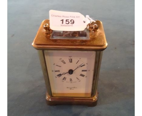 A brass cased carriage clock, having glazed side panels, the enamel dial signed Bornand Freres, Bicester (14cm handle up).