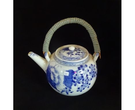 A Chinese ceramic teapot, having underglaze blue decoration and basket weave loop handle (20cm tall).