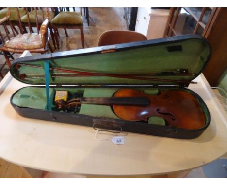 A cased violin and bow (in need of re-stringing).