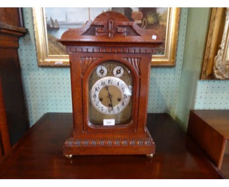An Edwardian oak cased chiming mantel clock, the movement signed Junghams and numbered A07, the gilt and silvered dial bearin