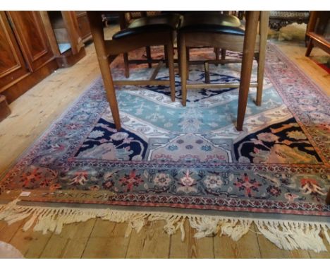 A Royal Keshan wool carpet, having stylized floral patterns on a jade, ivory and deep blue ground (230cm x 170cm).