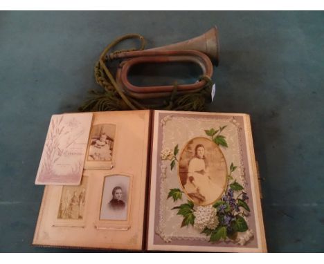 A brass military bugle stamped Marlborough College O.T.C., together with a Victorian photo album in leather bound cover, havi