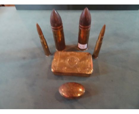 A WWI Christmas tin, together with four WWI shell cases and an engraved trench art snuff box dated 1915.