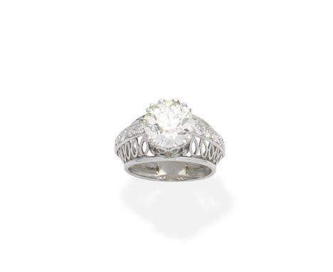 A diamond ringThe old brilliant-cut diamond weighing 4.88 carats, within a bombé openwork surround further accented by single