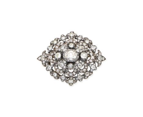 A diamond brooch/pendant, circa 1890Centrally-set with an oval-cut diamond, within a tiered openwork surround with fleur-de-l