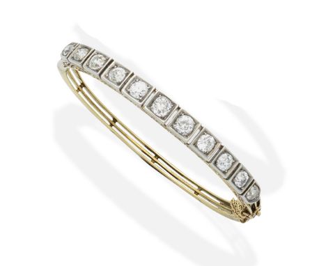 A diamond bangleThe trifurcated knifewire hinged bangle, set to the front with a series of old brilliant-cut and cushion-shap