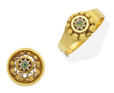 A mid 19th century gold, enamel and gem-set bangle and brooch suiteThe bangle set with a cushion-shaped green gemstone in a f