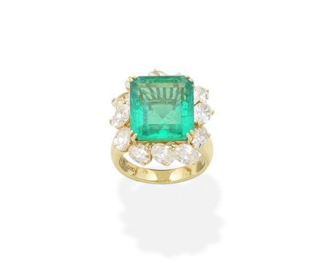 An emerald and diamond ringThe octagonal step-cut emerald within a surround of obliquely-set oval-cut diamonds,  diamonds app