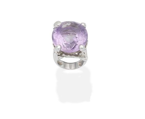 An amethyst and diamond dress ring, by DiorThe oval-cut amethyst to a mount of openwork foliate design, signed Dior, maker's 