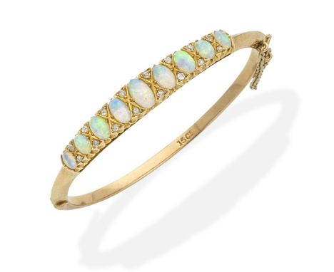 An opal and diamond bangle, circa 1890Of hinged design, set to the front with oval opal cabochons and single-cut diamonds, mo