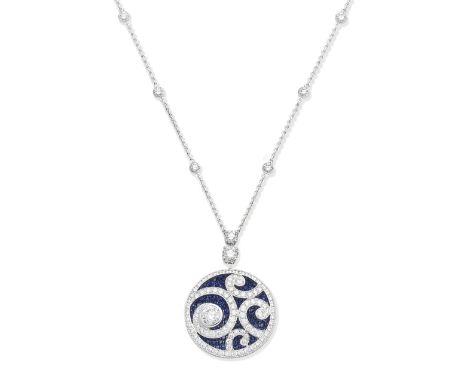 A sapphire and diamond pendant necklace, by GraffDesigned as a concave disc pavé-set with circular-cut sapphires, beneath an 