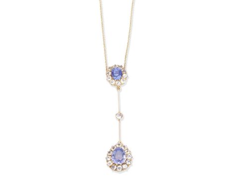 A sapphire and diamond pendent necklaceThe oval-cut sapphire and circular-cut colourless sapphire cluster suspending a simila