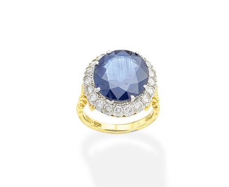 A sapphire and diamond cluster ringThe circular-cut sapphire within a brilliant-cut diamond surround, mounted in 18 carat whi