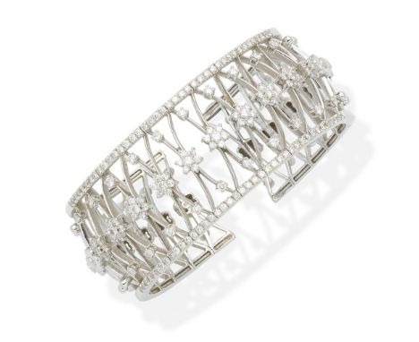 A diamond bangleThe sprung bangle designed as a knifewire lattice with brilliant-cut diamond accents, a row of similarly-cut 