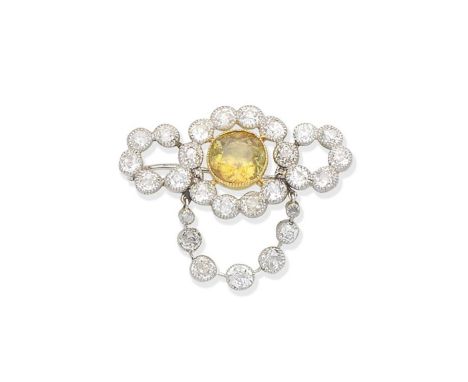 A sphene and diamond broochThe central cushion-shaped sphene within an openwork surround of old brilliant and cushion-shaped 