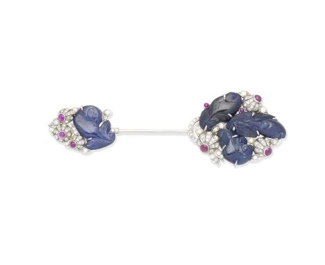 An Art Deco sapphire, diamond and ruby jabot pin, circa 1935Each terminal set with stylised carved sapphire leaves and circul