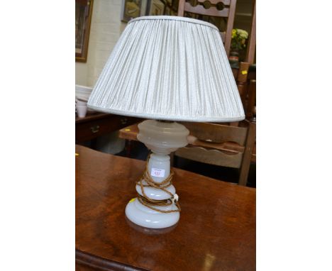 A milk glass paraffin lamp, converted for electricity, with pleated shade