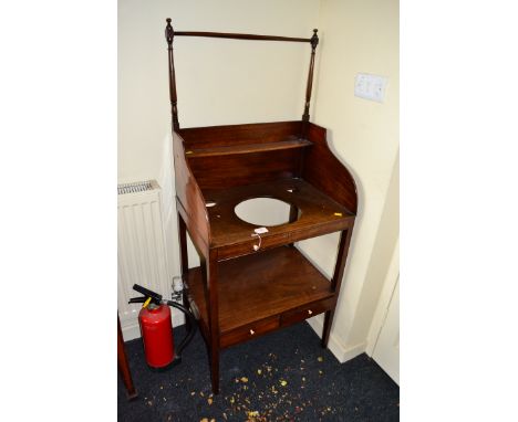 A George III mahogany washstand, having a rail and shelf superstructure over provision for basin, two faux and two true drawe