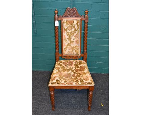A Victorian walnut high backed nursing chair, with later tapestry upholstery