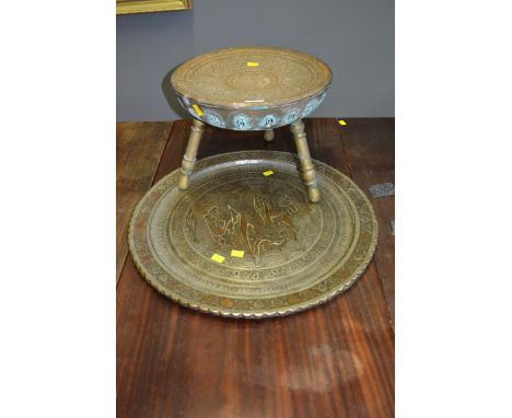 A Persian silver on copper charger, decorated with figures in a landscape, 58cm, together with a dome seated three legged sto