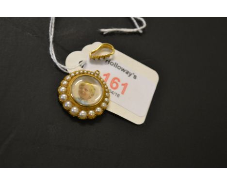 An Edwardian portrait miniature of a young fair haired boy, set in a 15ct gold mount pendant with seed pearl surround