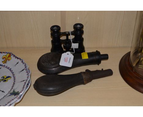 A pair of late 19th/early 20th century black painted field glasses, stamped Williams, leather shot flask, and a copper powder