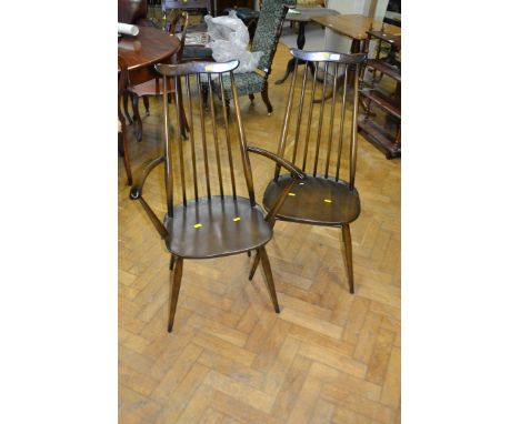 A set of six Ercol dining chairs, each with eared rail, stick back on splayed turned supports (two carver, four standard)