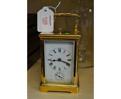 A 20th century brass cased carriage clock, with gong striking repeating, eight day movement