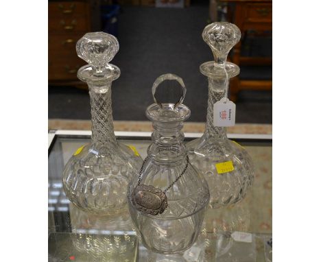 A George III, probably Irish, triple ring necked decanter, with diamond and panel cut decoration and facet tab stopper, toget