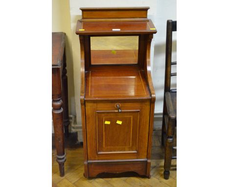 An Edwardian mahogany and strung coal purdonium, having shelf over mirror back, the fall front with period metal liner, on br