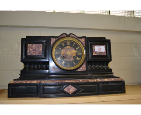 A Victorian black slate and rouge marble mantel clock with eight day bell striking movement