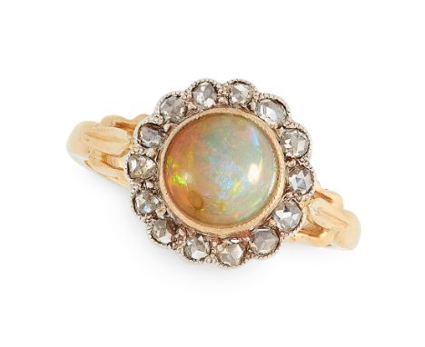 AN ANTIQUE OPAL AND DIAMOND RING in yellow gold and silver, set with a circular cabochon opal within a border of rose cut dia