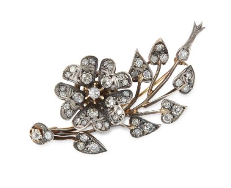 A DIAMOND EN TREMBLANT SPRAY BROOCH in yellow gold and silver, designed as a floral spray, with en tremblant flower, set with