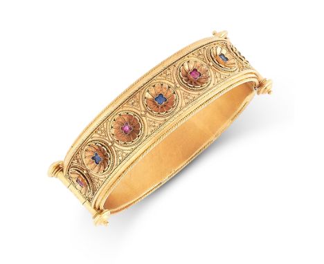 AN ANTIQUE RUBY AND SAPPHIRE BANGLE, LATE 19TH CENTURY in 18ct yellow gold, in the Etruscan revival manner, formed of two cur