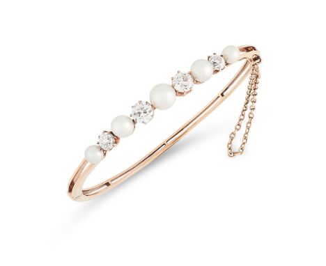 AN ANTIQUE NATURAL PEARL AND DIAMOND BANGLE, EARLY 20TH CENTURY in 14ct yellow gold, the band set with a row of five graduate