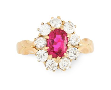 A BURMA NO HEAT RUBY AND DIAMOND RING in 18ct yellow gold, set with an oval cut ruby of 1.38 carats within a border of old cu