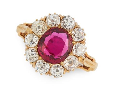 AN UNHEATED RUBY AND DIAMOND RING in 18ct yellow gold, set with an oval cut ruby of 2.04 carats within a border of old cut di